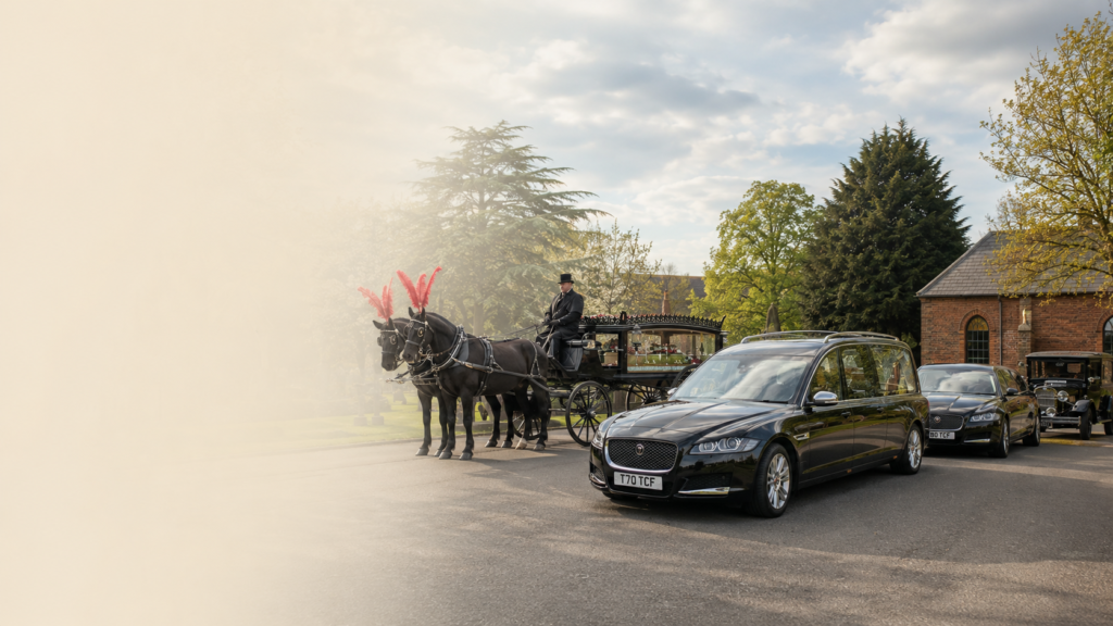 Funeral transport vehicles including a black Jaguar hearse, limousine and horse-drawn carriage in Sunderland
